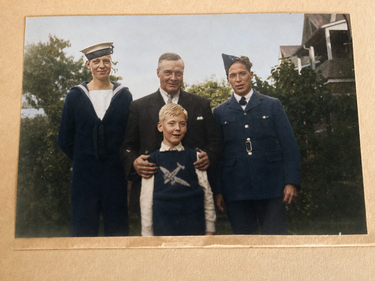 Four McCollums in a garden: Bob in navy uniform, their father John in a suit, Bill in RCAF uniform, and young Jack in front
